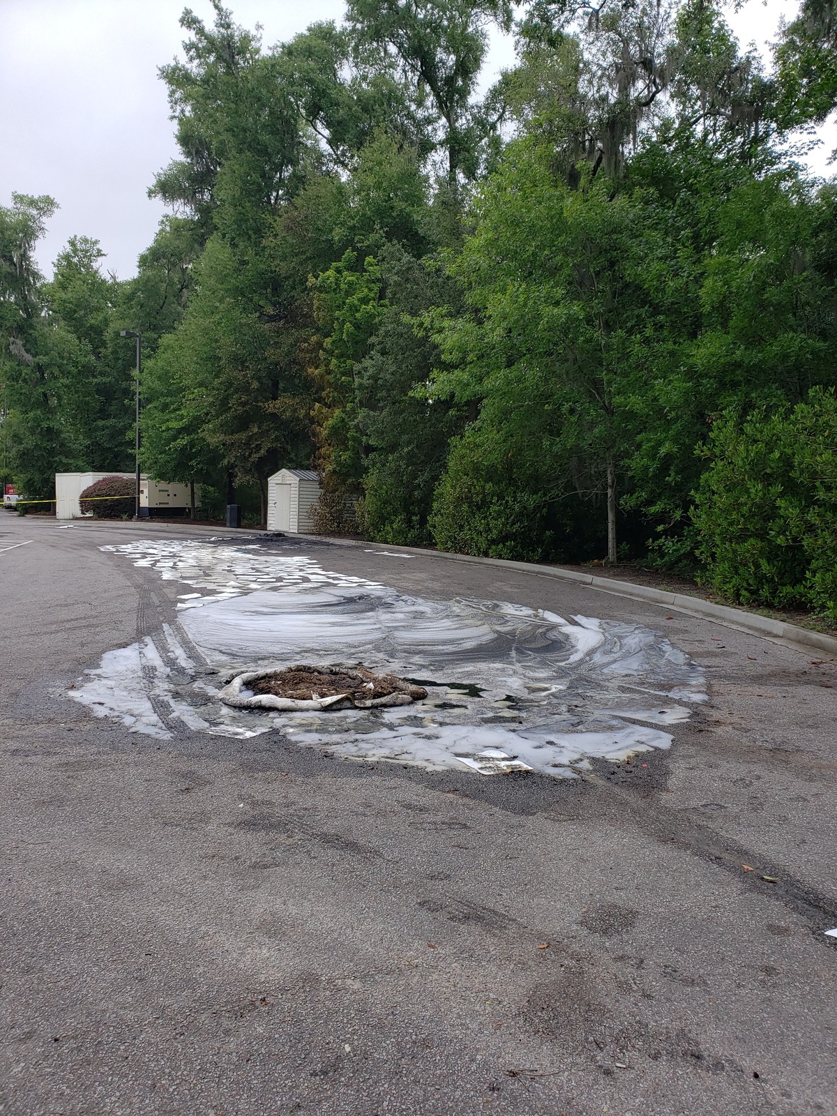 S.C. health officials deploy firefighting foam with oil absorbing boom to keep pollutants out of the storm drain.