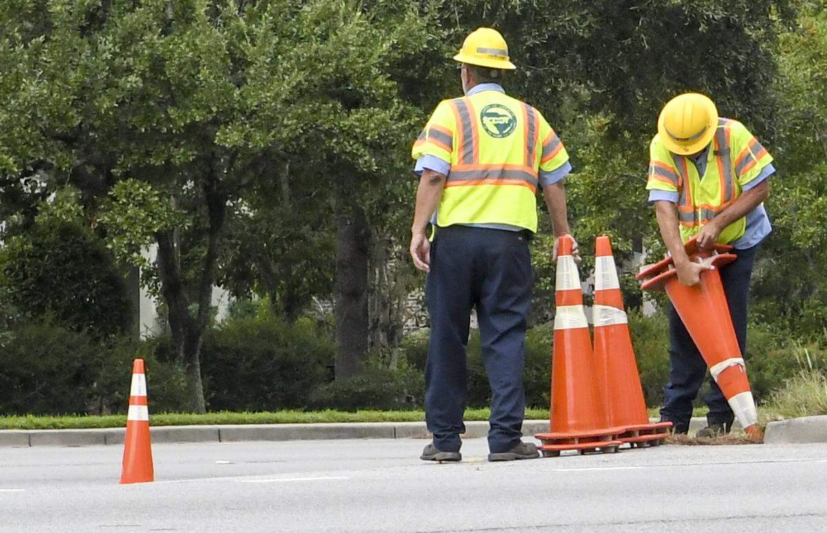 A worker with S.C. Department of Transportation struggles to free pylons in order to use for lane reversals on eastbound US 278 on Monday morning near the base of the bridges to Hilton Head Island. Lane reversals were initiated for the potential arrival of Hurricane Dorian, currently a Category 5 storm.