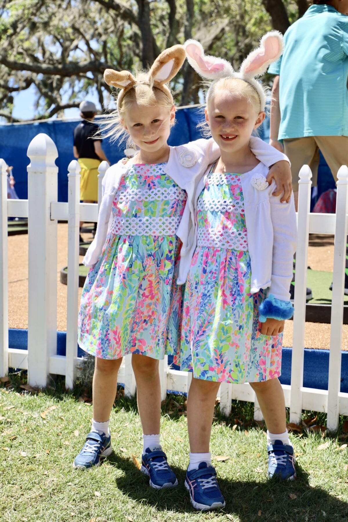 Anna and Ella Asbrey match each other with their Lilly dresses and bunny ears. These twins are the definition of cute with their electric blue sneakers and bunny ears.