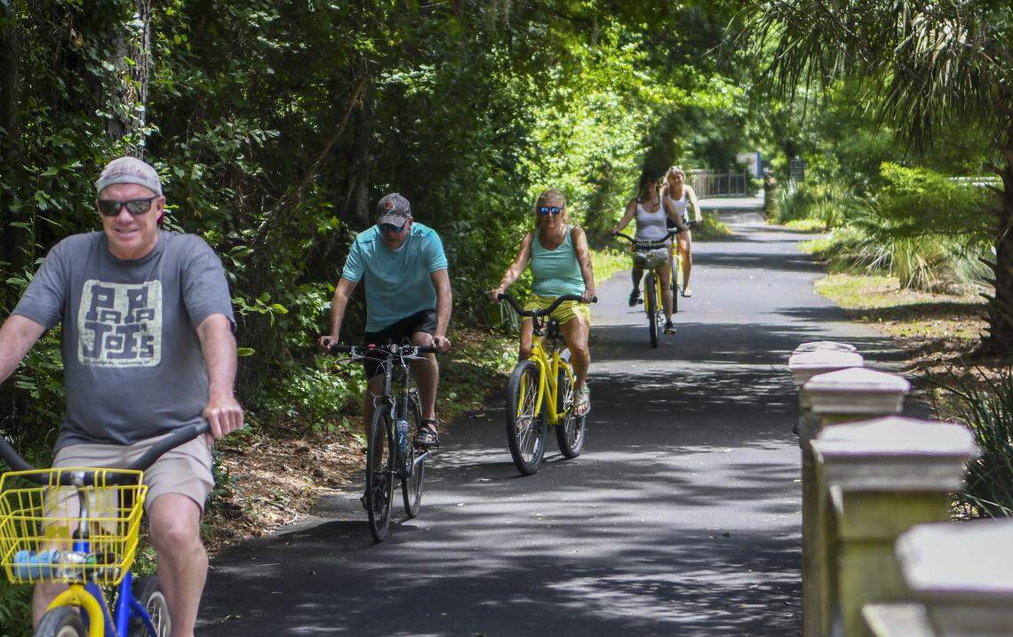 A group of cyclists pedal their way down a bike path along Pope Avenue on Friday, May 15, 2020 on Hilton Head Island, calling out “We’re from Ohio.” when asked whether they were visiting.