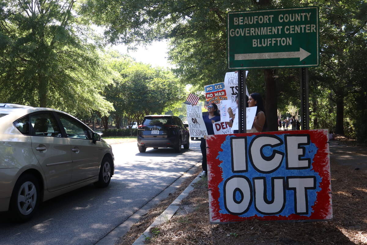About 100 protesters gathered on the side of Bluffton Parkway on June 5, 2026, to oppose a U.S. Immigration and Customs Enforcement operation a week earlier where numerous residents were detained in the Bluffton area. The protest was held outside the Myrtle Park Government Center, where the detainees were briefly held before being loaded onto a bus in the local ICE operation.
