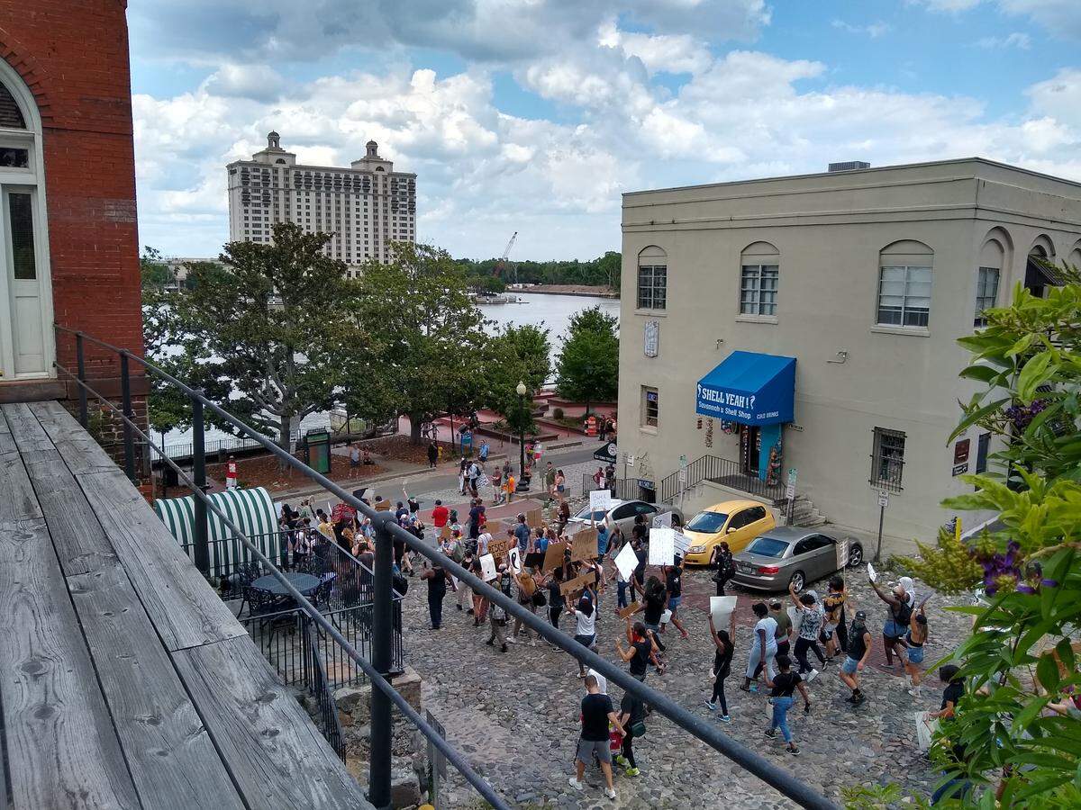 Protesters march toward River Street in Savannah on Sunday, May 31, 2020 while demonstrating against police violence after the death of George Floyd in Minneapolis days earlier.