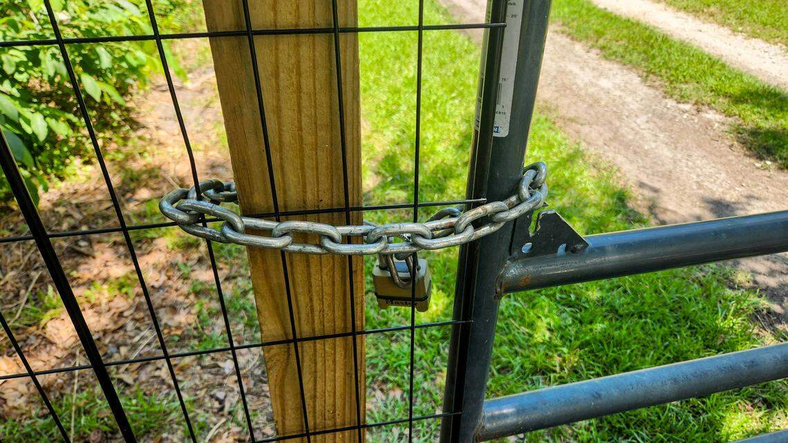 The locked gate at Terri Aigner’s property and neighbors as photographed on Wednesday, July 10, 2024 at the end of Everest Road on St. Helena Island. Aigner, who maintains that the road is private, placed the gate after numerous vehicles and large trucks used by funeral homes, damaged the road after a heavy rainfall, leaving it impassable.