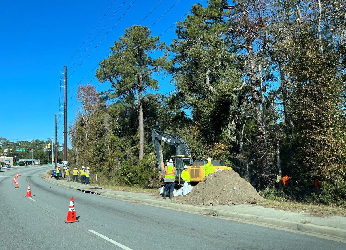 Workers with Beaufort Jasper Water and Sewer Authority work on a sewage spill near the intersection of Parris Island Gateway and Savannah Highway.