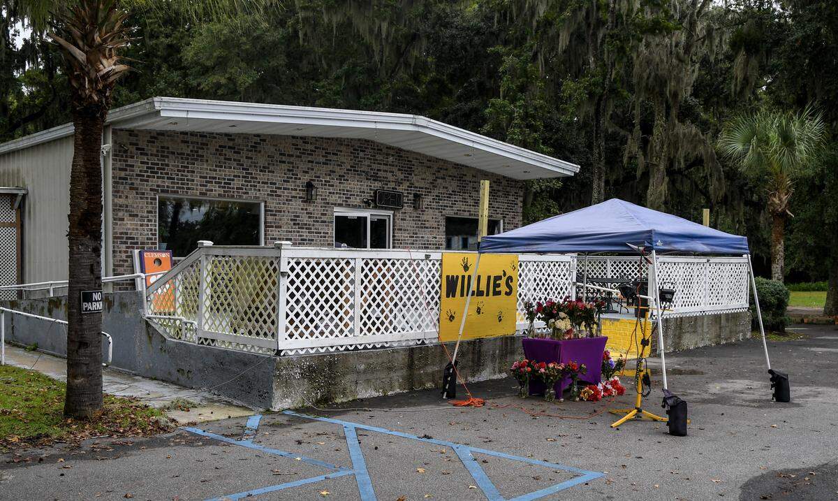 A memorial table is set up outside of Willie’s Bar and Grill as photographed on Oct. 13, 2025, after a mass shooting took place that killed four people outside the establishment in the early morning hours of Sunday on St. Helena Island.