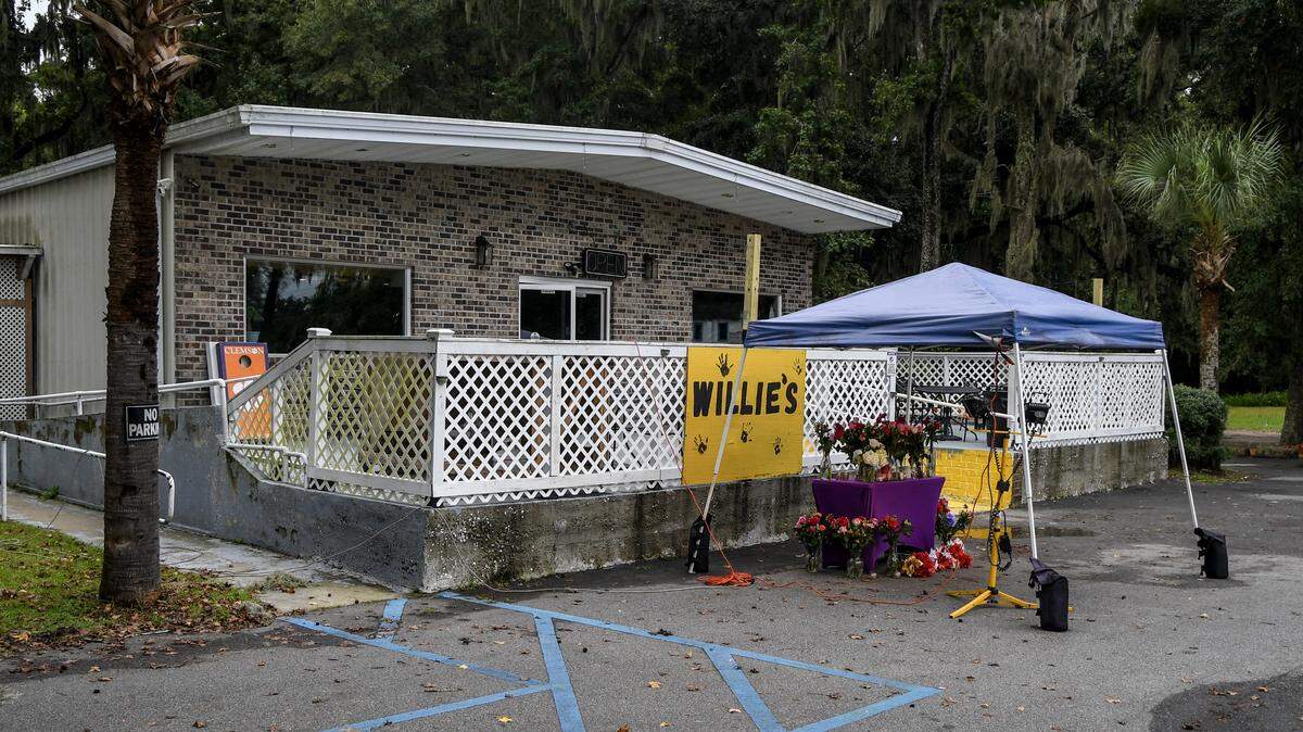 A memorial table is set up outside of Willie’s Bar and Grill as photographed on Oct. 13, 2025, after a mass shooting took place that killed four people outside the establishment in the early morning hours of Sunday on St. Helena Island.