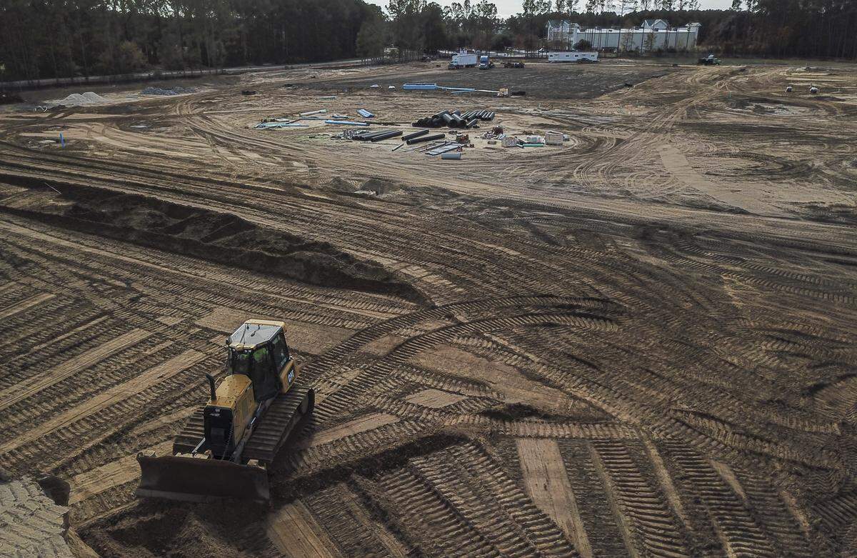 A bulldozer sits idle by a mound of dirt on Wednesday afternoon at Hilton Head Christian’s new school site located at Masters Way and Bluffton Parkway in Bluffton as Lowcountry Community Church’s campus is seen in the background. Although there is no vertical construction, the school is expected to be open for the 2020-21 school year.