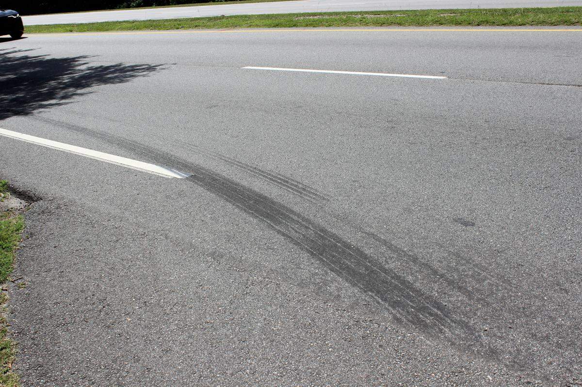 Skid marks on the road from a car that swerved towards pro-Trump demonstrators on U.S. 278 on June 14, 2025. “They want us dead,” said Bluffton resident Debbie Barton.