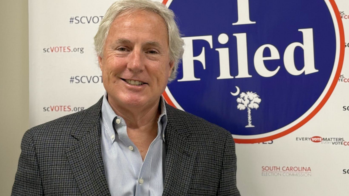 Democratic primary winner Trey Judy holding his candidacy filling papers.
