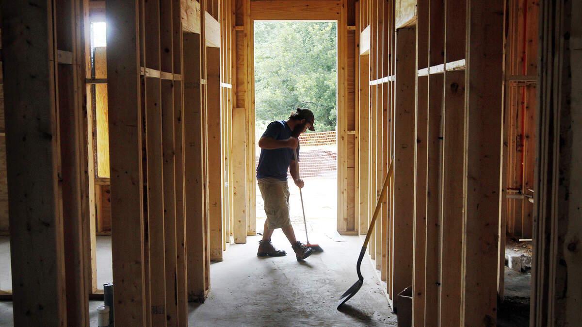 Dusty Kimberly, 26, of Butler's Plumbing Services sweeps Friday after working on the construction site of the new Bauer Dental Associates in the Bluffton Promenade in Old Town.