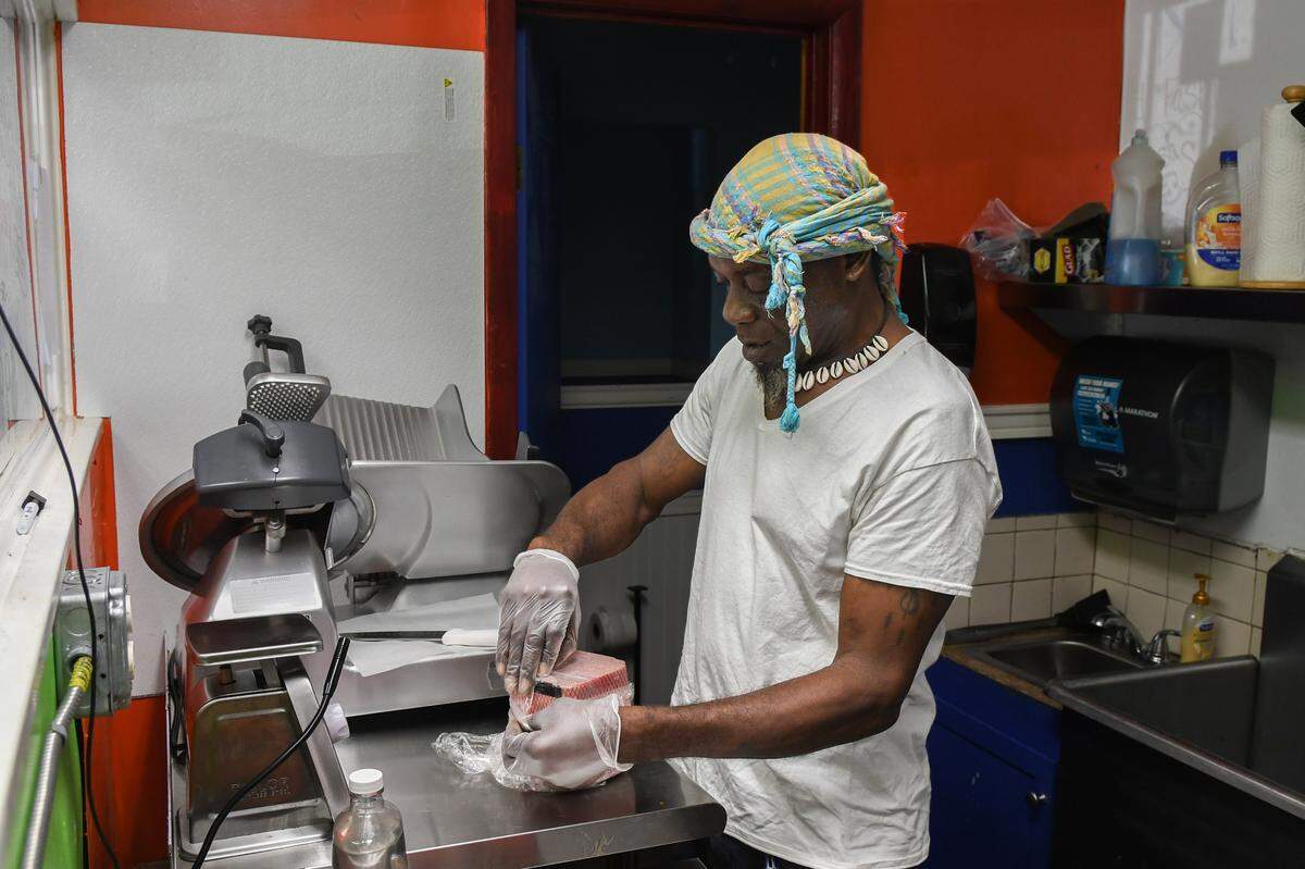 Columbus “Lum” Allen prepares to cut some deli meat at Fountain Island Blue Convenience Store on Thursday, June 27, 2024 on St. Helena Island. Recently remodeled and under new management, the store offers a deli counter, lottery tickets, bait for fishing and a full-service car wash.