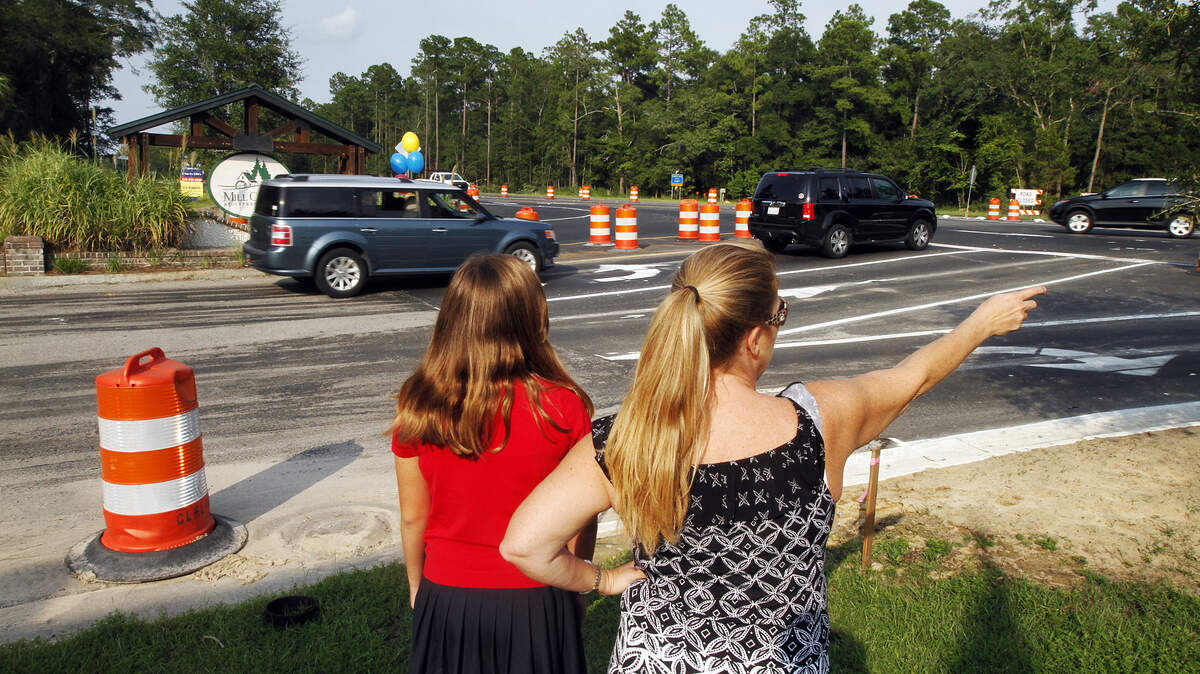 Katherine Swanson, and her daughter Mary Grace, 11, watch as traffic becomes congested at the intersection of Mill Creek Boulevard and SC 170 on Aug. 14, 2014. Swanson wants to see county engineers install a traffic light at the intersection, which they say will occur next spring once construction is complete. "It's a matter of time before someone gets in a bad accident or worse outside of the Mill Creek neighborhood, and it's only going to get worse with the additional lanes going in later this year...," Swanson said. "It's frightening, is the best way to put it."