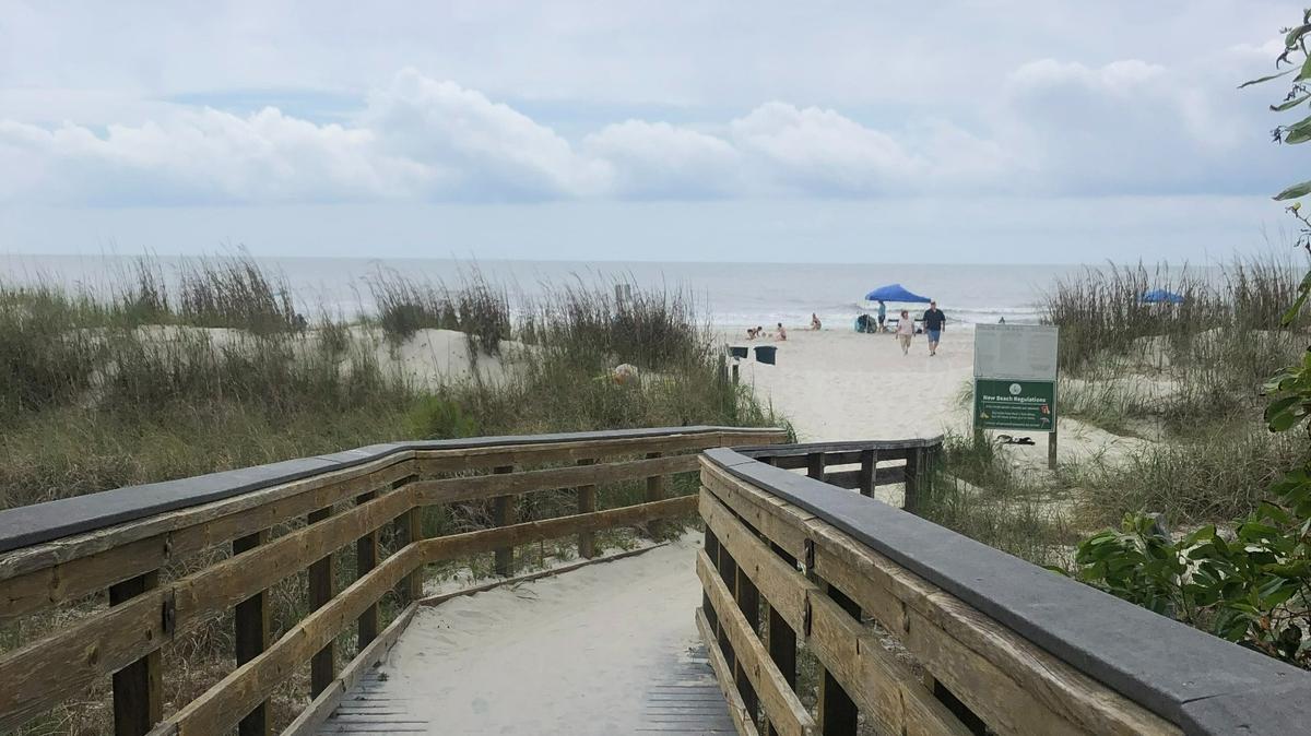A boardwalk in Palmetto Dunes leads to a crowded Hilton Head Island beach on Memorial Day weekend 2021.