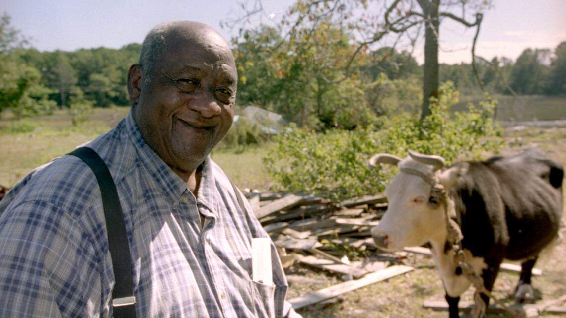 Arthur Frazier is shown with his pet cow, Miss Earline, at his home on Jonesville Road in October 2000. 