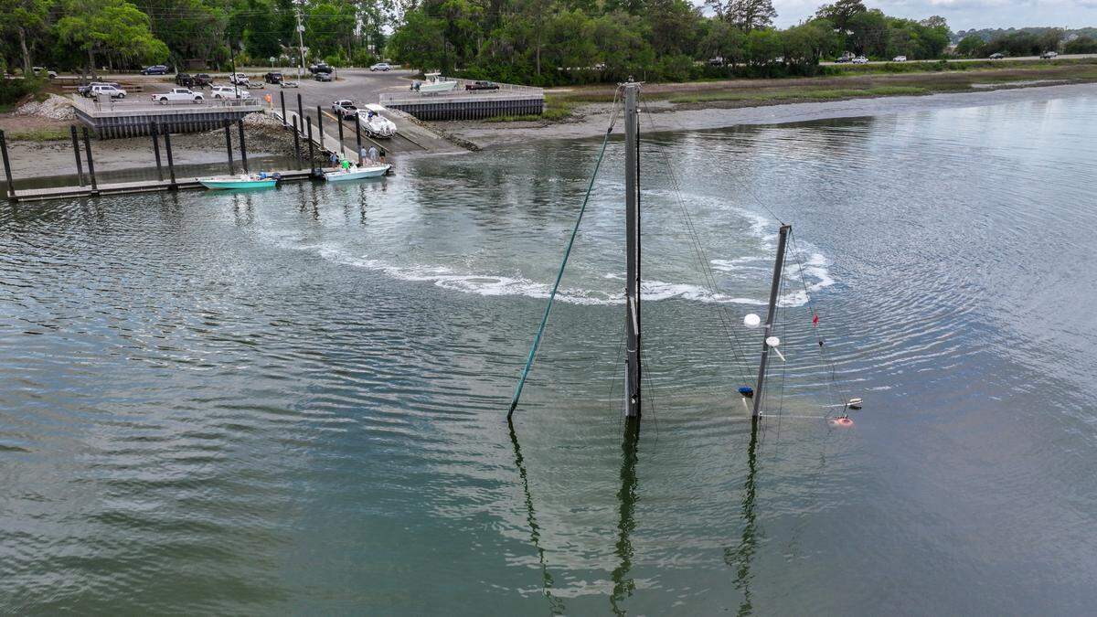 Masts from a sunken sailboat can be seen protruding from Factory Creek on April 23, 2025, directly across from the Whitehall Boat Landing as people take their boat out of the water on Ladys Island.