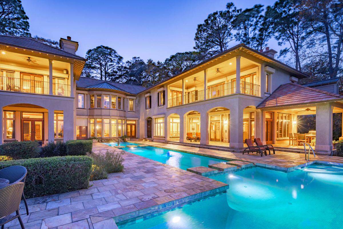A look behind the residence, which features two reflection pools leading to a main pool, found at 30 Oyster Shell Lane on Hilton Head Island, SC.