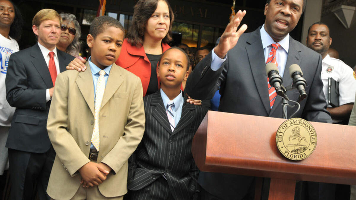 With his family beside him -- from left, son Joshua, 10, wife Santhea and son Jordan, 8 -- Jacksonville mayor-elect and Beaufort native Alvin Brown addresses the audience on the steps of City Hall on May 19. Outgoing Jacksonville Mayor John Peyton stands to the left behind Joshua Brown. 