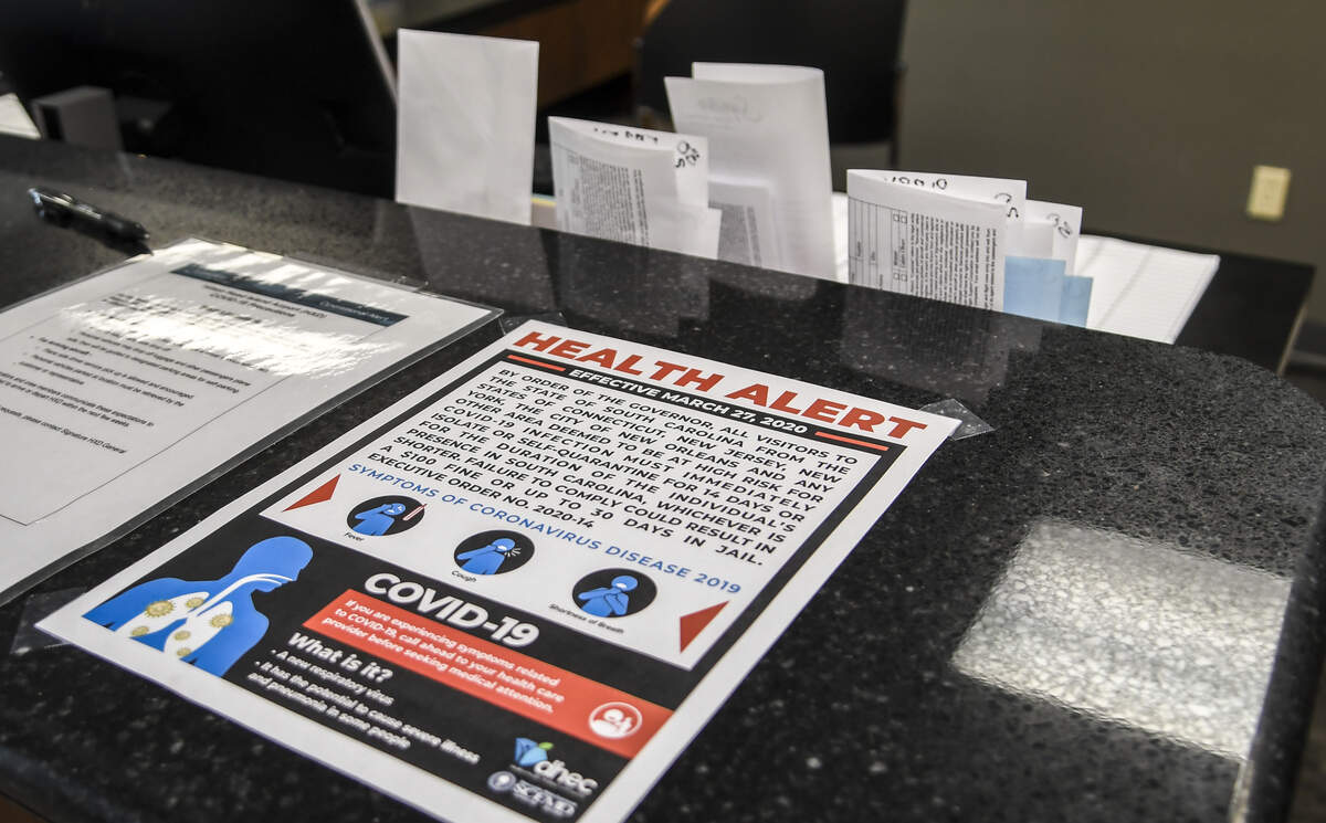 A health alert is taped to the counter at Signature Flight Support HXD as seen on Monday, March 30, 2020, that informs travelers arriving from COVID-19 hotspots that they must, on behalf of S.C. Gov Henry McMaster recently enacted law, self-quarantine for 14-days or for the duration of their visit.