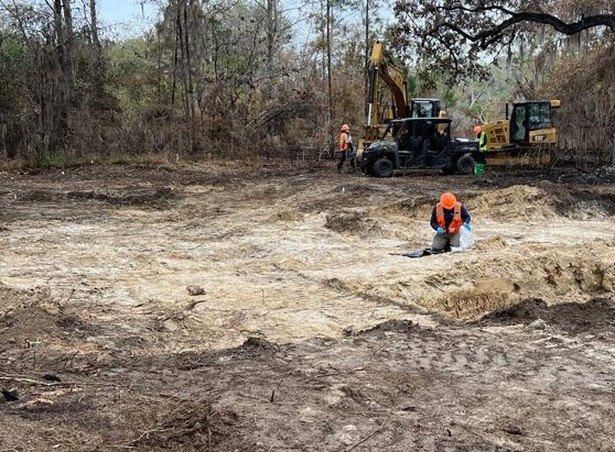 U.S. Navy contractors conduct soil sampling as part of the clean up after an F/A-18 crashed near Marine Corps Air Station Beaufort March 3.