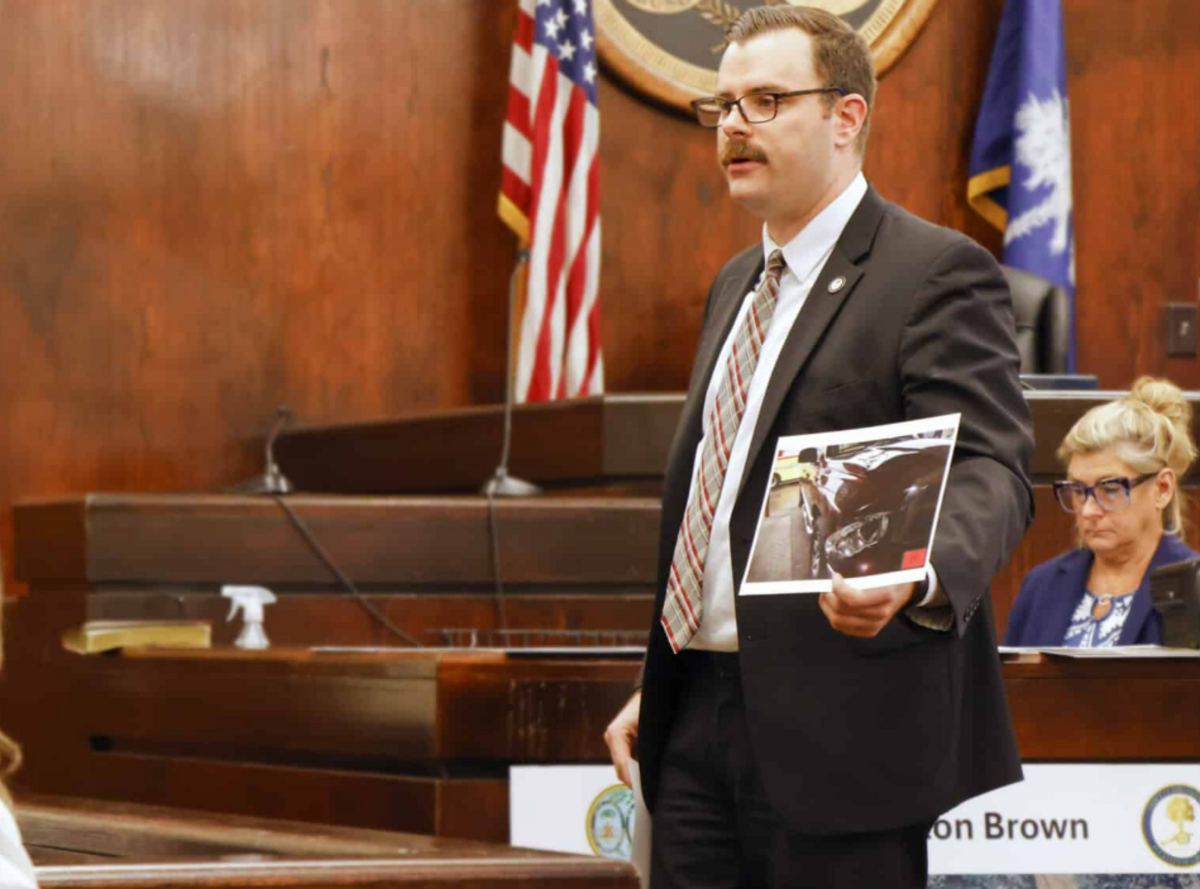 Assistant Solicitor Jared Shedd shows a photo of damage to the headlight of a vehicle driven by defendant Clinton Brown that struck and killed pedestrian Redeidre Holmes in 2020. Brown was sentenced to eight years in prison and three years of probation on June 25, 2026, after a Beaufort County jury found him guilty of fleeing the scene of the fatal accident.