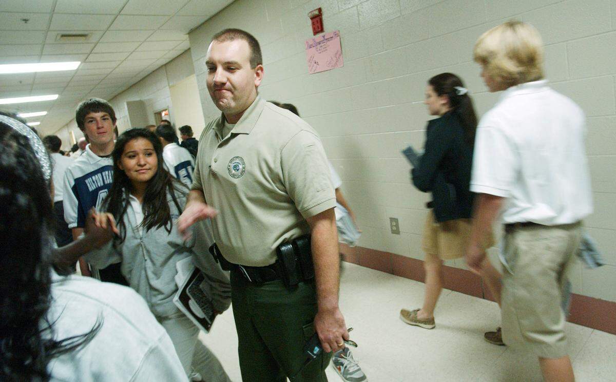 Beaufort County Sheriff’s Office deputy Mike Tannuzzi, Hilton Head Island Middle’s school resource officer, jokes with some eighth graders, including Dillon Nadzak and Felicita Romaro Barragan, in the hallway during a class change in 2009.