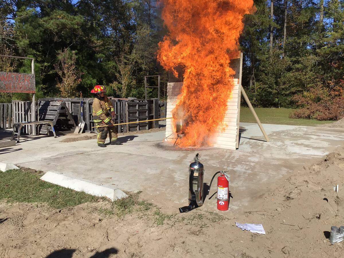A firefighter from the Burton Fire District displays what can happen when a fire is ignited while improperly frying a turkey.