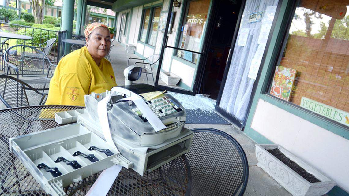 Dye Scott Rhodan, of Dye's Gullah Fixin's restaurant at Hilton Head's Pineland Station, waits for the glass repair company to arrive on Wednesday after her restaurant was broken into overnight. Rhodan said whoever smashed out her front door and destroyed her cash register -- costing her $900 in repairs alone -- netted a total of 19 cents from the otherwise empty register. "You work so hard to try to make it, and somebody comes behind you and tries to take it," she said. Though she was unable to serve lunch on Wednesday, Dye said she planned to be back in business in time to server dinner evening. "You keep praying, you keep the faith and you keep moving on," she said.