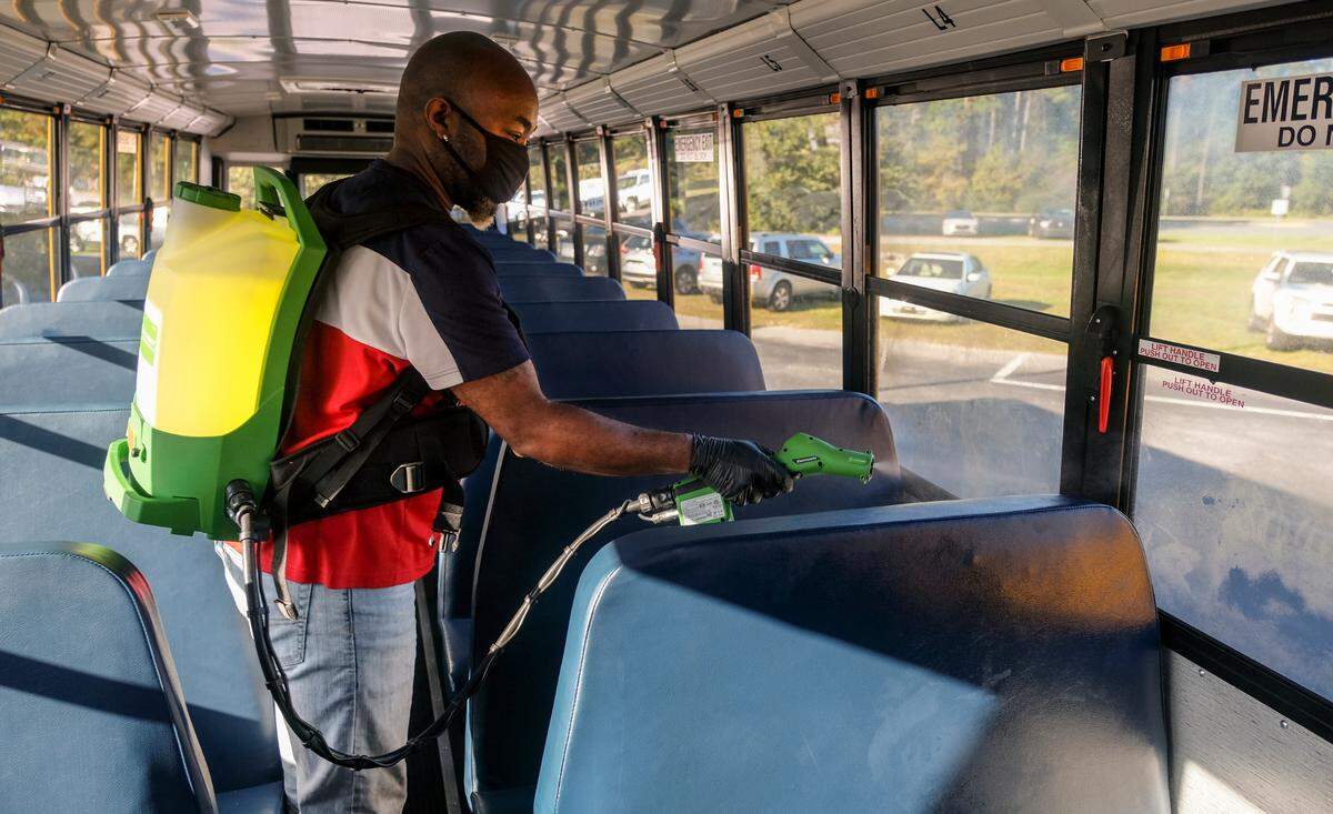 Maurice Brown, Bluffton transportation supervisor, uses a cordless electrostatic sprayer for disinfecting school buses on Thursday, Nov. 19, 2020 at the Bluffton school complex located along Buckwalter Parkway in Bluffton.