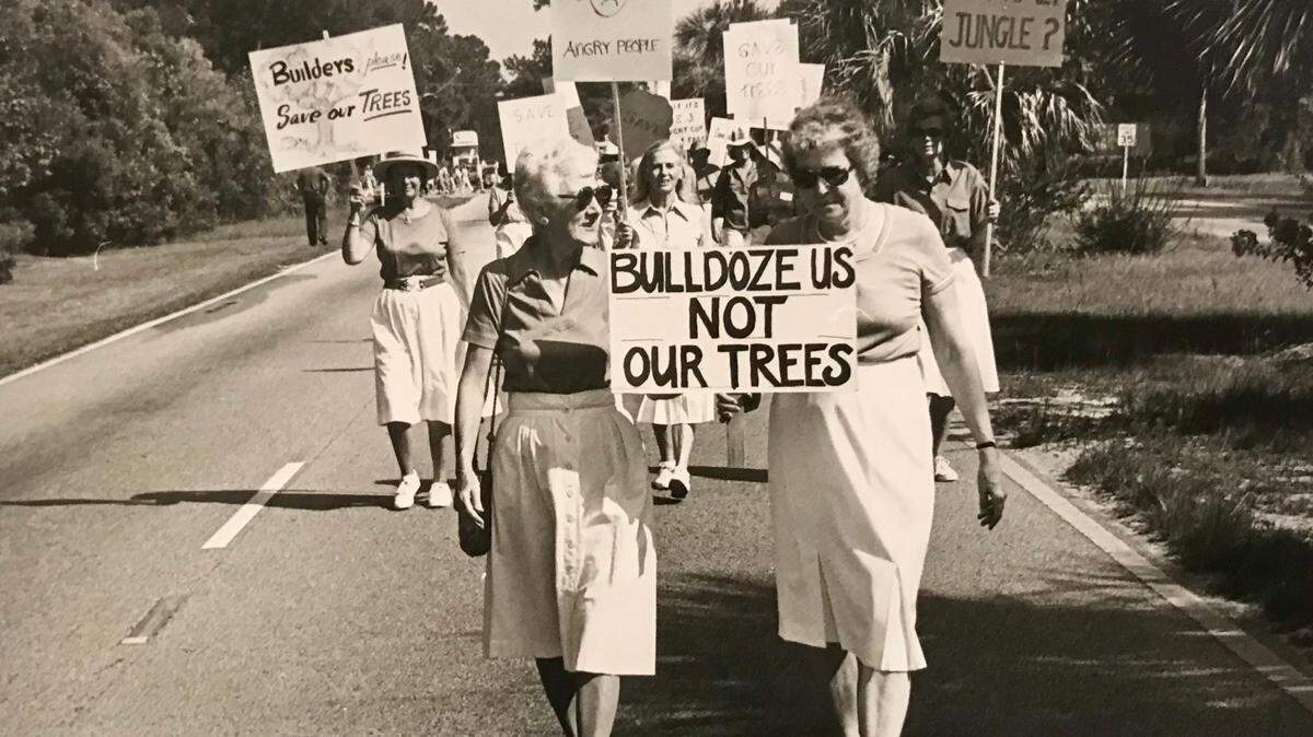 Katie Callahan, left, and Dorothea Griffin lead a “Save Our Trees” march down Pope Avenue on Hilton Head in July 1984.