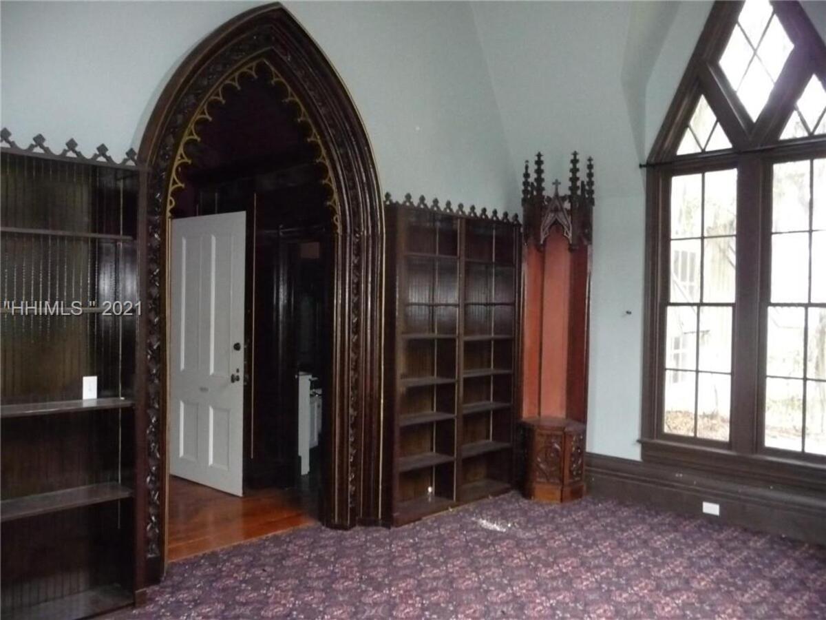 Built in bookshelves line a wall in the Rose Hill Mansion’s library.