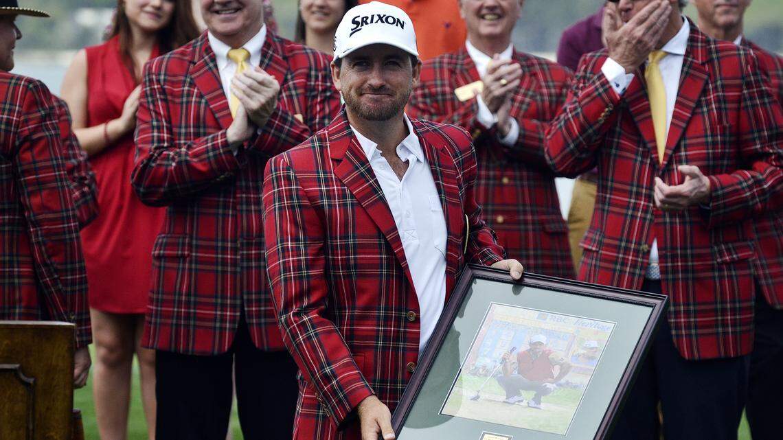 Defending champion Graeme McDowell displays framed artwork he received during the opening ceremonies for the 46th Annual RBC Heritage Presented by Boeing on Monday afternoon at Harbour Town Golf Links in Sea Pines on Hilton Head Island. To watch a video, go to: http://bit.ly/1gf1c6W