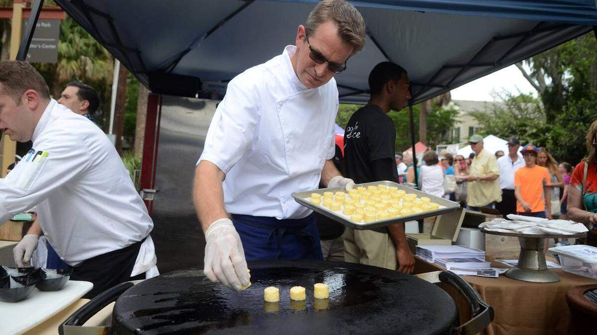 Ray Lammers, executive sous chef at The Inn at Palmetto Bluff, put grit cakes on a large griddle during the Third Annual Taste of Bluffton on Calhoun Street in 2015.