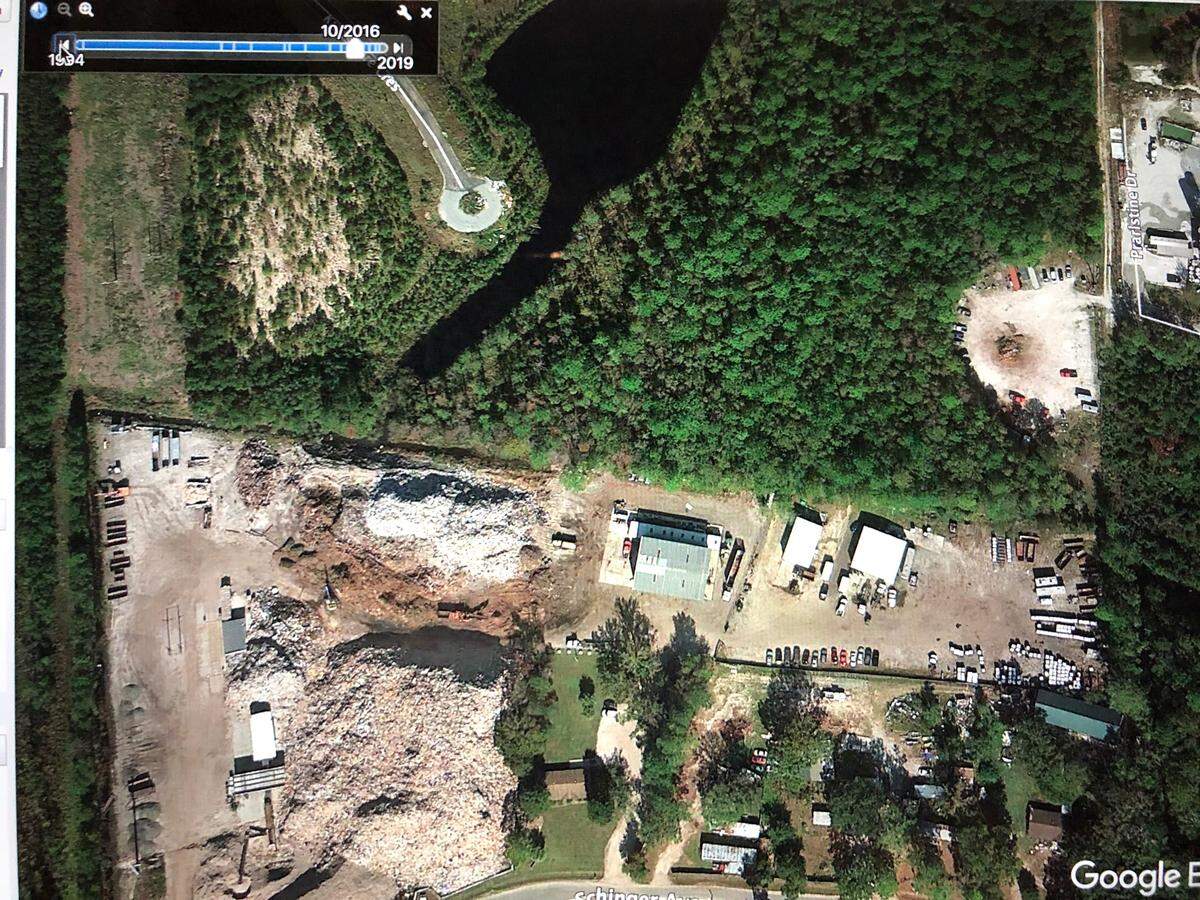 A screenshot of a Google Earth photograph from October 2016 shows the Able Contracting property and the surrounding drainage ditch and retention pond. Green layers of bacteria and nutrients are not visible.