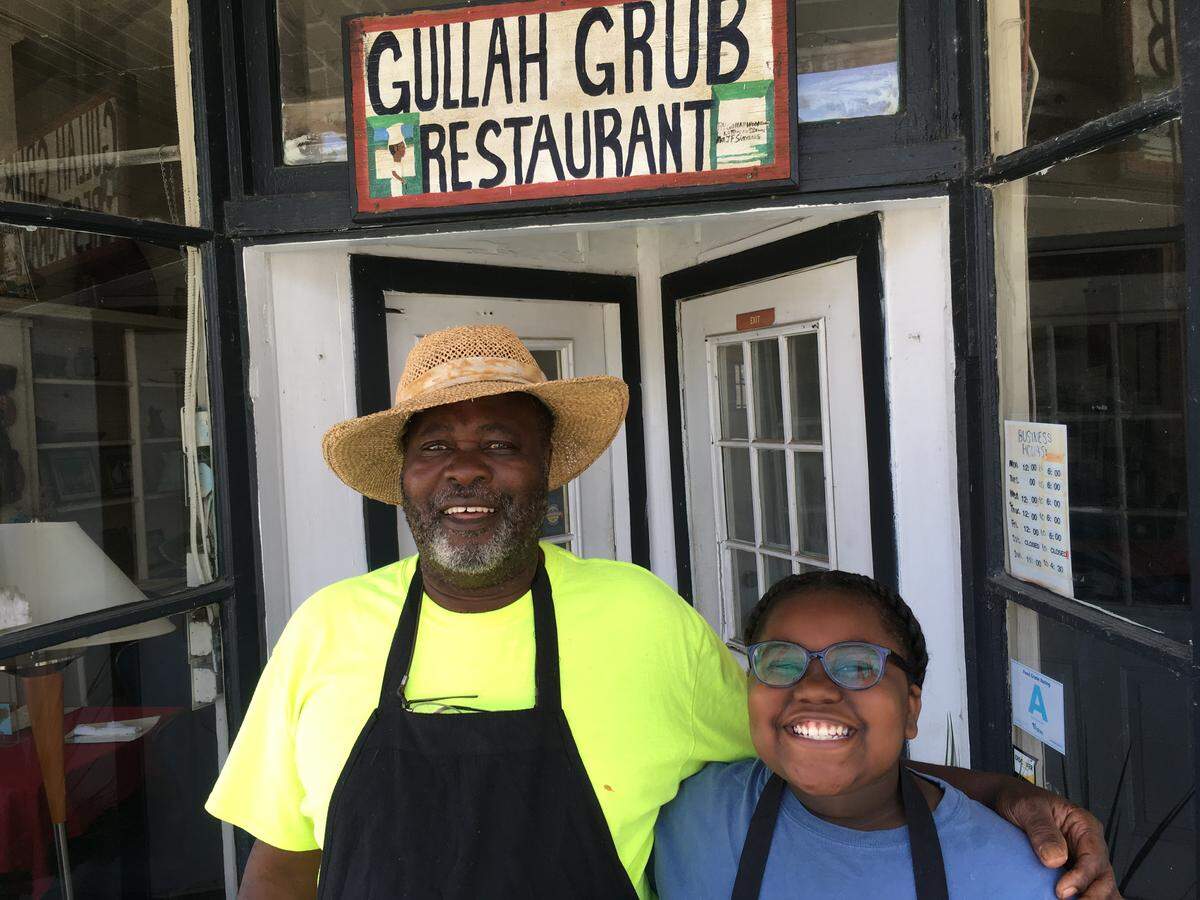 Bill Green, owner and chef at Gullah Grub restaurant on St. Helena Island, stands with granddaughter Zariya, 11, in front of the restaurant on Thursday, June 14, 2018. Green's restaurant was featured by Anthony Bourdain's Travel Channel television show in 2007.