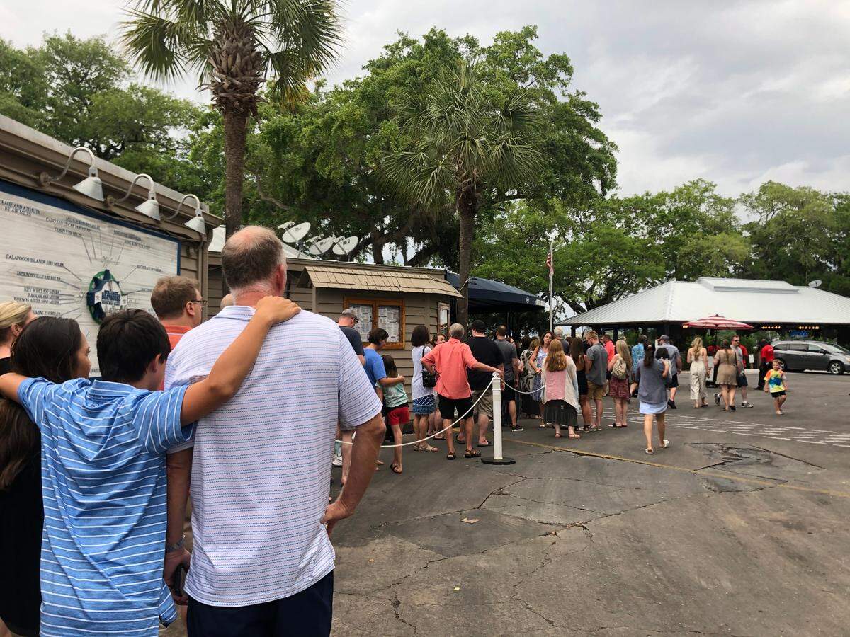 The line to check in for a table at Skull Creek Boathouse wraps around the building on Thursday, June 3. Once diners checked in, the restaurant was running a two-hour wait.