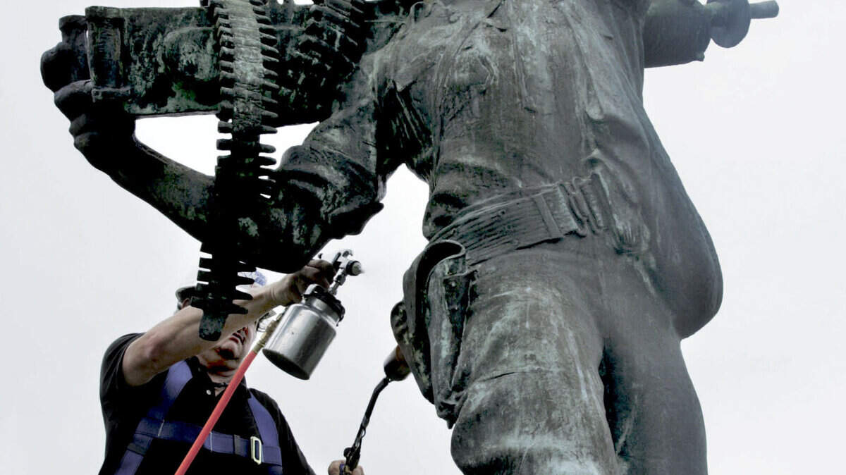 Ted Monnich, an art preservation specialist from Columbia, works on Iron Mike earlier this month at Marine Corps Recruit Depot Parris Island. The 85-year-old statue  received a $13,000 makeover to remove mold and oxidization that was damaging the monument.
