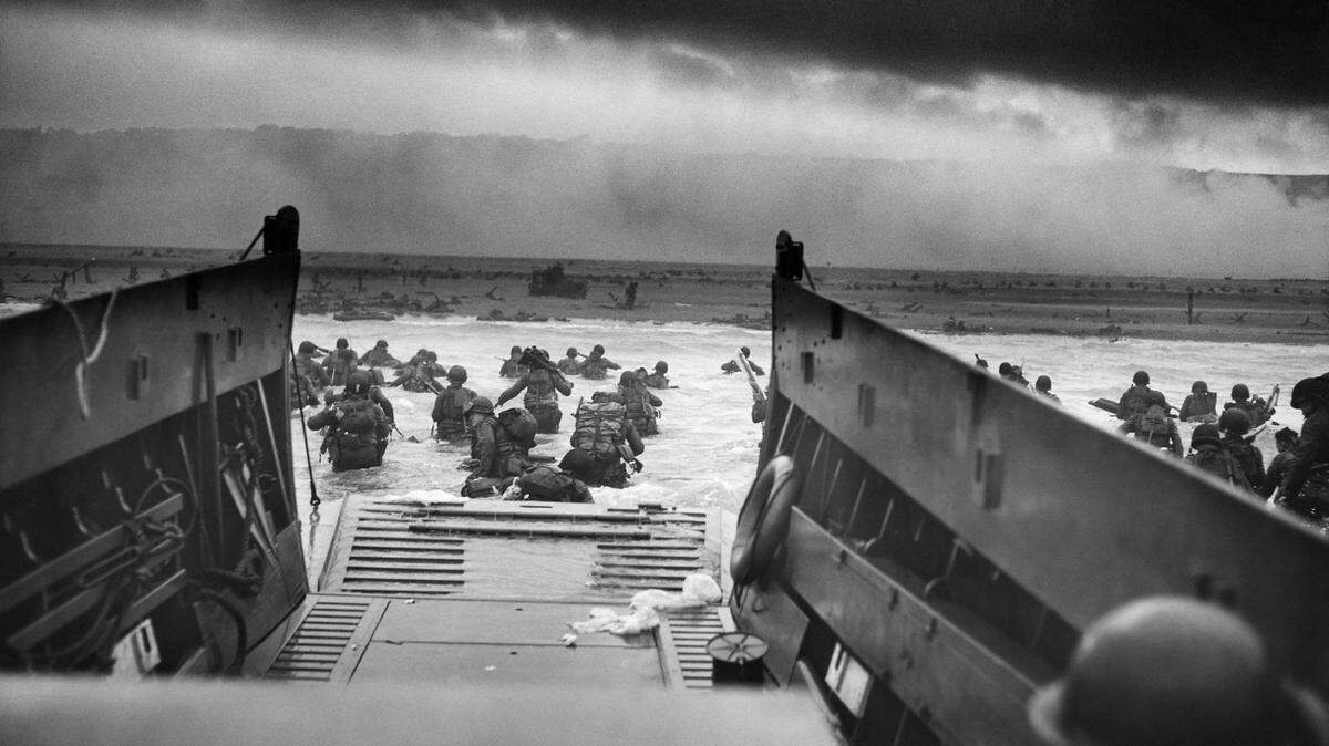 An LCVP (Landing Craft, Vehicle, Personnel) from the U.S. Coast Guard-manned USS Samuel Chase disembarks troops from Company E, 16th Infantry, 1st Infantry Division (the Big Red One), wading onto Fox Green section of Omaha Beach on June 6, 1944.