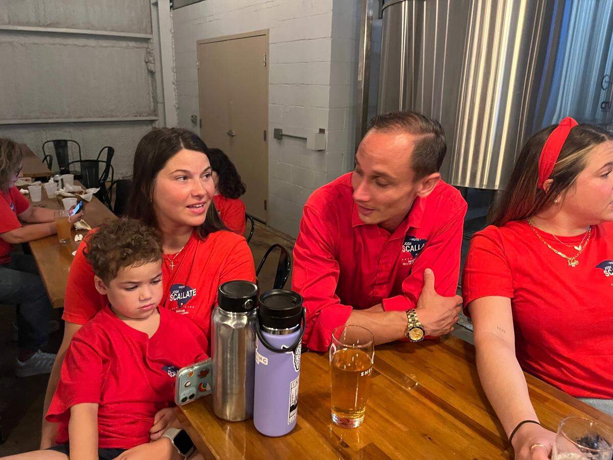 Josh Scallate awaits election results with his supporters, including his son, Jake, at the Shellring Ale House Tuesday evening.