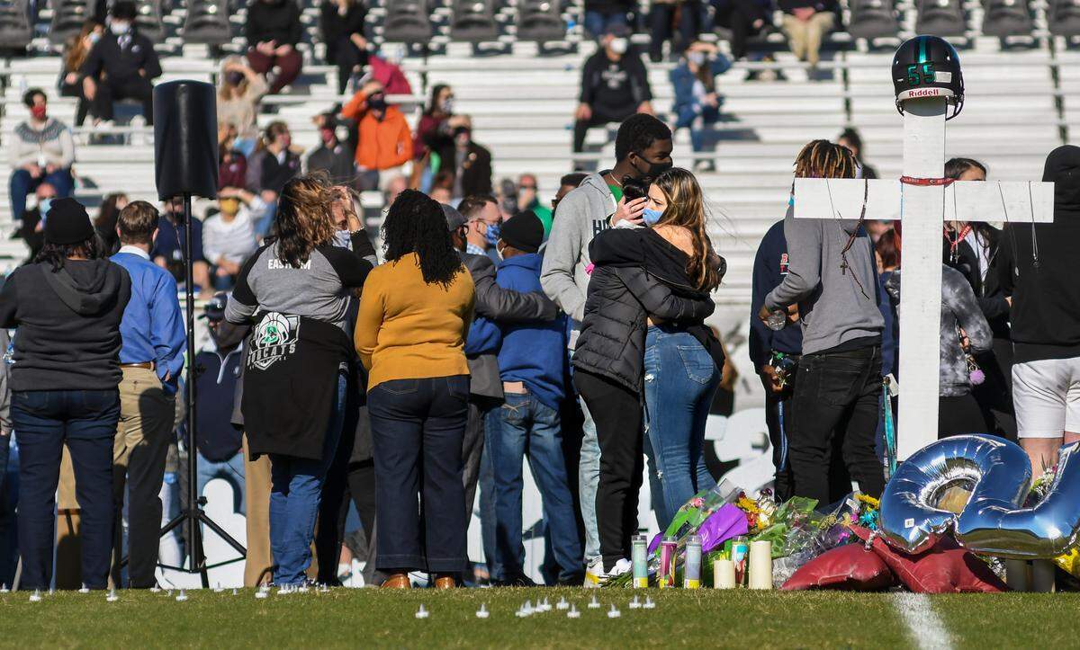 Friends comfort each other before the start of the public vigil for Dwon “D.J.” Fields Jr. on Sunday, March 7, 2021, at Bluffton High School.