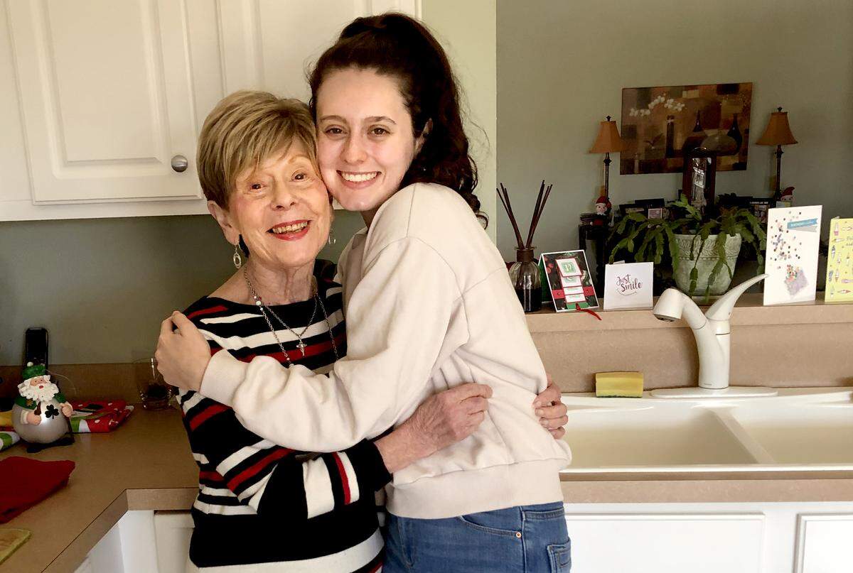 Marie Rafferty, left, with her granddaughter Mackenzie in her clean home. Rafferty was selected for “Cleaning for a Reason,” a national program that matches people with cancer with local cleaning services to donate free cleaning.