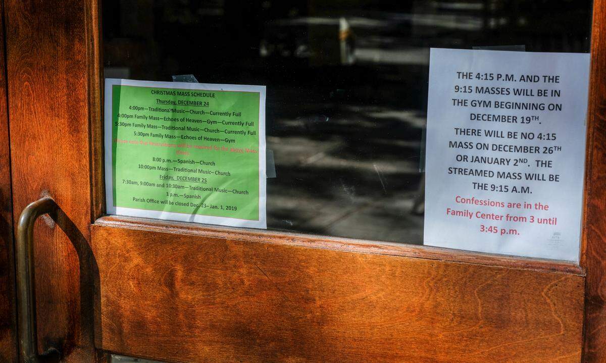 Signage on the door of Hilton Head Island’s St. Francis by the Sea Catholic Church on Wed., Dec., 23, 2020 instructs congregants they must reserve a space for Christmas Eve and Christmas Day music and Mass due to the coronavirus pandemic.