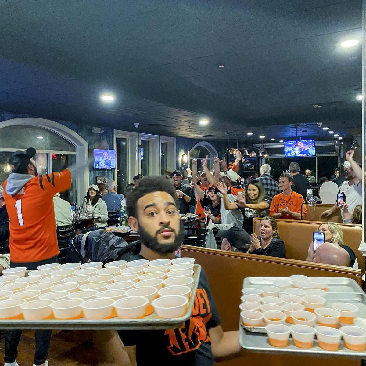 Jaylin Wright, manager at Hilton Head’s Rock Fish Seafood & Steaks at Bomboras, juggles trays of orange jello shots after the Cincinnati Bengals beat the Las Vegas Raiders on Jan. 15, 2022.