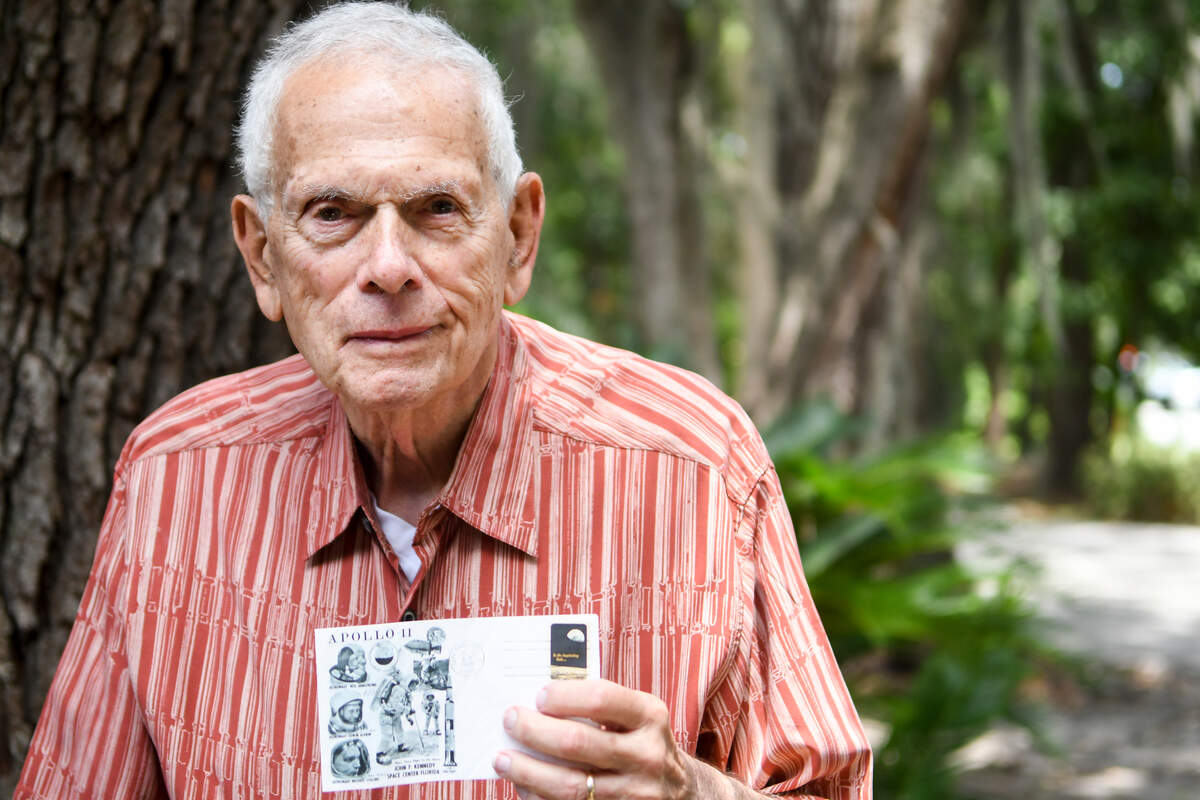 Norman Solon, a resident of Sun City Hilton Head, stands for a portrait on Friday afternoon as he holds his commemorative envelope that features the three astronauts of the Apollo 11 with a postmark from Cape Canaveral of July 16, 1969 and a six-cent, Apollo 8 postage stamp.