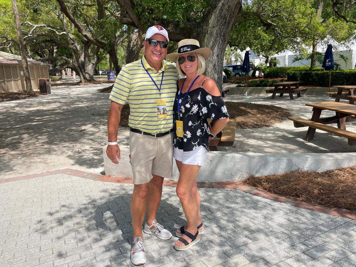 Joe and Pam Lenart pose for a photo in Harbour Town during the RBC Heritage Presented by Boeing 2022 tournament.