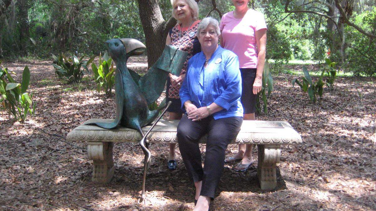 Lois Schuhrke sits with the whimsical Walter Palmer bird sculpture at its new home, with Char Long, immediate past president of the Women's Association of Hilton Head Island, left, and current president Judith Tyler. 