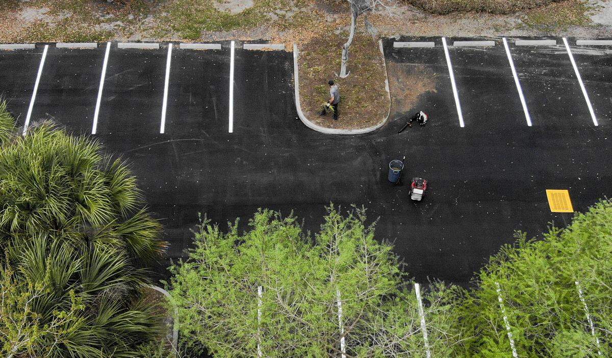 A lone landscaper works at Tanger Outlets 2 on Tuesday, March 24, 2020 in greater Bluffton. City and county officials are grappling with closing non-essential businesses during the coronavirus pandemic to slow the spread of COVID-19.