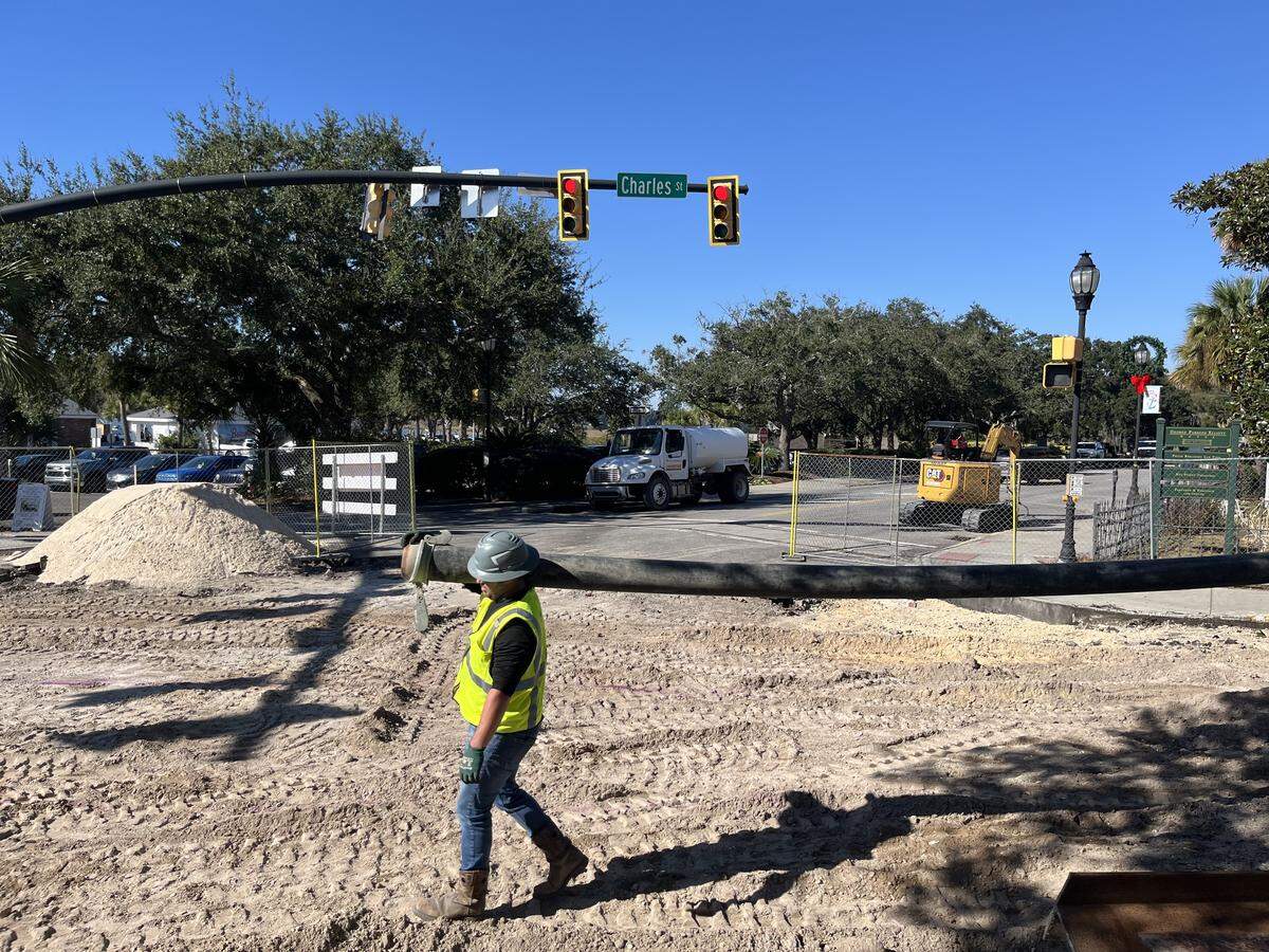 Workers move piping into position at the intersection of Bay and Charles streets in downtown Beaufort on Friday.