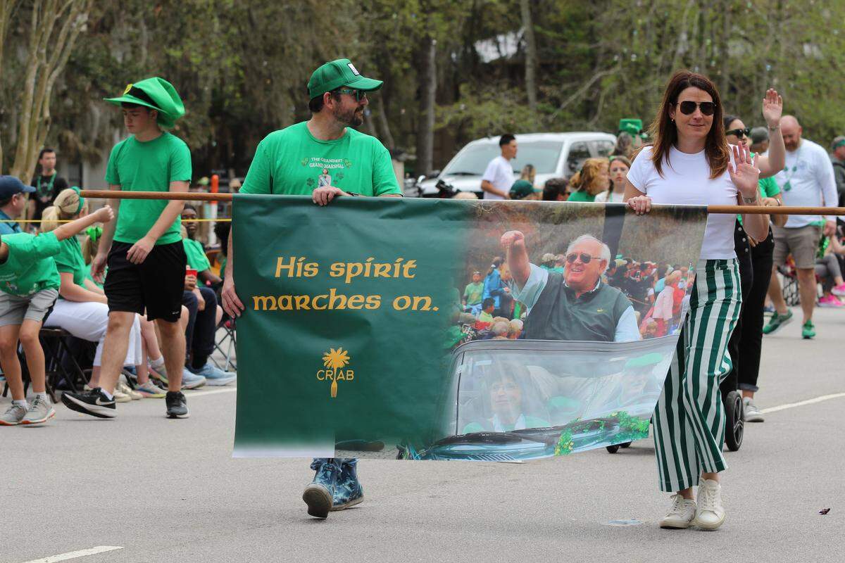 Thomas and Catherine Reilley hold up a banner honoring their father, Tom Reilley, who passed away from health complications last year. Tom Reilley founded the St. Patrick’s Day Parade more than 40 years ago, and was a beloved icon of Hilton Head Island.