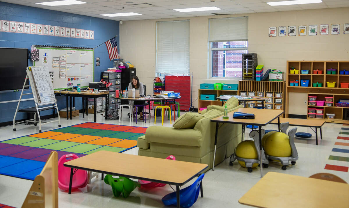 In an empty classroom, a Pritchardville Elementary School teacher huddles over her laptop while on a virtual call with her students on Tuesday, Sept. 8, 2020 - the first day of school. The Beaufort County School District opted to start the school year remotely due to the coronavirus pandemic.