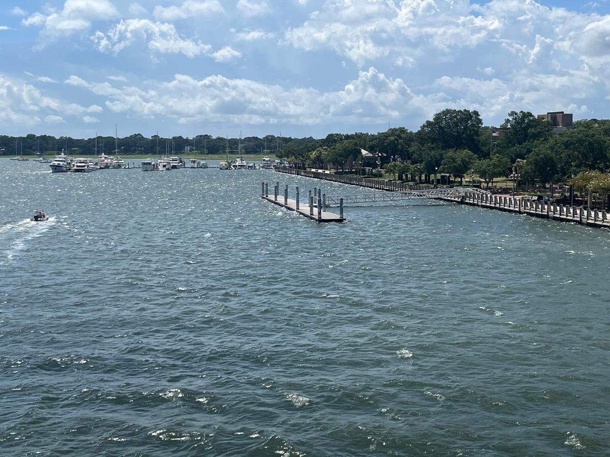 A boat speeds past the Waterfront Park promenade in Beaufort Tuesday afternoon. The promenade was closed to the public Monday because of structural concerns. The rest of Waterfront Park and the businesses located between the park and Bay Street, Beaufort’s main street, remain open. The day dock shown in the photo is closed, too.